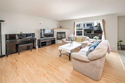 96 Panamount Manor Nw, Calgary, AB - Indoor Photo Showing Living Room With Fireplace