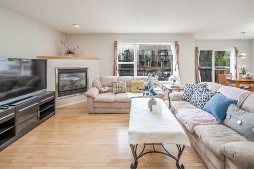 96 Panamount Manor Nw, Calgary, AB - Indoor Photo Showing Living Room With Fireplace