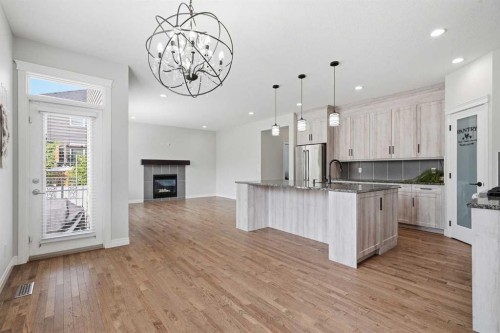 44 Cimarron Springs Circle, Okotoks, AB - Indoor Photo Showing Kitchen With Fireplace With Upgraded Kitchen
