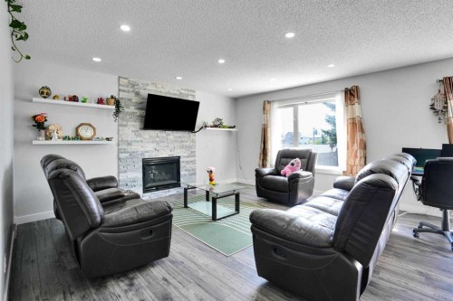 101 Douglas Ridge Circle Se, Calgary, AB - Indoor Photo Showing Living Room With Fireplace
