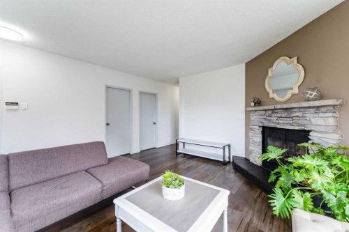 1502 40 Street Se, Calgary, AB - Indoor Photo Showing Living Room With Fireplace