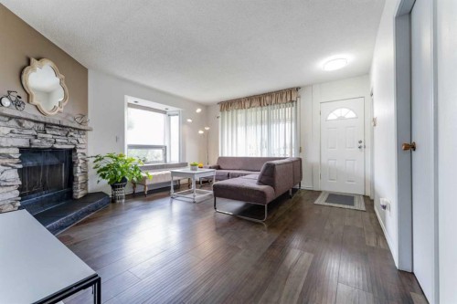 1502 40 Street Se, Calgary, AB - Indoor Photo Showing Living Room With Fireplace