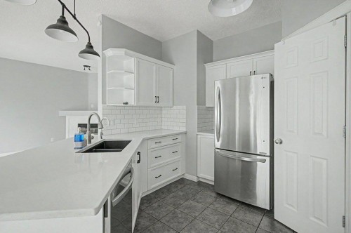 218 Cougarstone Circle Sw, Calgary, AB - Indoor Photo Showing Kitchen With Stainless Steel Kitchen With Double Sink With Upgraded Kitchen
