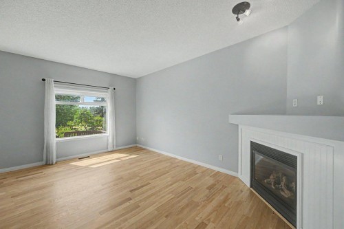 218 Cougarstone Circle Sw, Calgary, AB - Indoor Photo Showing Other Room With Fireplace