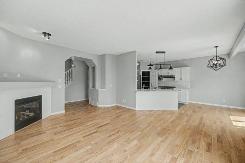 218 Cougarstone Circle Sw, Calgary, AB - Indoor Photo Showing Living Room With Fireplace