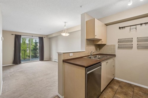 1305-8 Bridlecrest Drive Sw, Calgary, AB - Indoor Photo Showing Kitchen With Double Sink