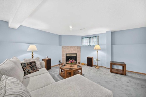 18 Shawbrooke Rise Sw, Calgary, AB - Indoor Photo Showing Living Room With Fireplace