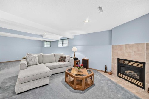 18 Shawbrooke Rise Sw, Calgary, AB - Indoor Photo Showing Living Room With Fireplace