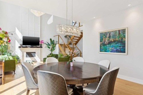 23 Elveden Park Sw, Calgary, AB - Indoor Photo Showing Dining Room With Fireplace