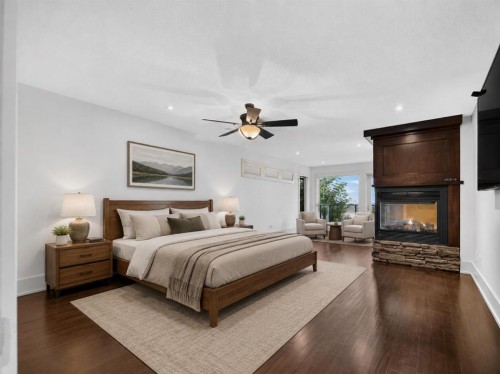 2724 Signal Ridge View Sw, Calgary, AB - Indoor Photo Showing Bedroom With Fireplace