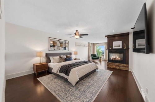 2724 Signal Ridge View Sw, Calgary, AB - Indoor Photo Showing Bedroom With Fireplace