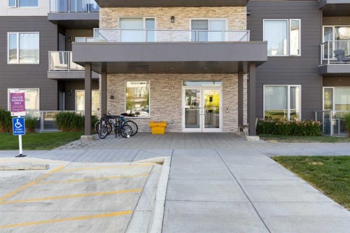 202-150 Shawnee Square Sw, Calgary, AB - Outdoor With Balcony With Facade