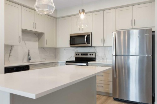 202-150 Shawnee Square Sw, Calgary, AB - Indoor Photo Showing Kitchen With Stainless Steel Kitchen With Upgraded Kitchen