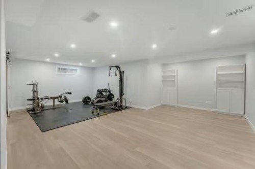 100 Fairways Drive Nw, Airdrie, AB - Indoor Photo Showing Gym Room