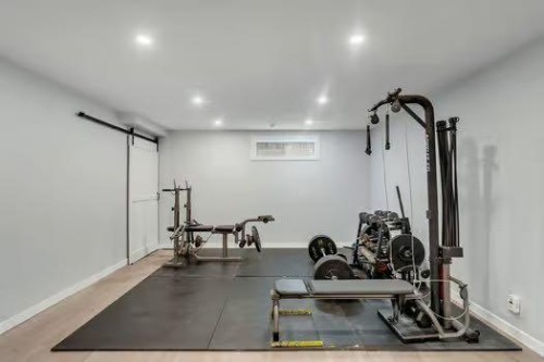 100 Fairways Drive Nw, Airdrie, AB - Indoor Photo Showing Gym Room