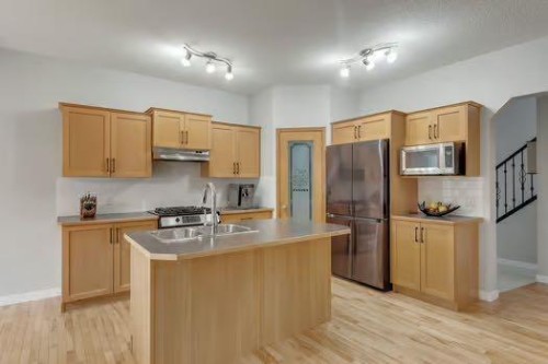 100 Fairways Drive Nw, Airdrie, AB - Indoor Photo Showing Kitchen With Double Sink