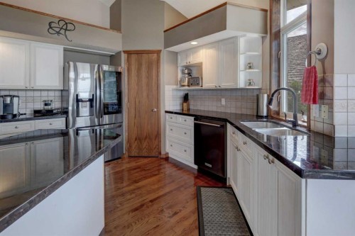 321 Gleneagles View, Cochrane, AB - Indoor Photo Showing Kitchen With Double Sink