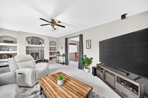 121 Chapalina Heights Se, Calgary, AB - Indoor Photo Showing Living Room With Fireplace