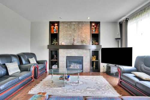126 Panatella Crescent Nw, Calgary, AB - Indoor Photo Showing Living Room With Fireplace