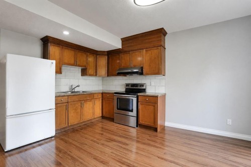 126 Panatella Crescent Nw, Calgary, AB - Indoor Photo Showing Kitchen With Double Sink