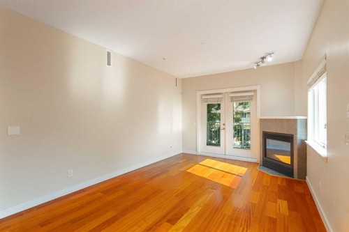 202-509 21 Avenue Sw, Calgary, AB - Indoor Photo Showing Other Room With Fireplace