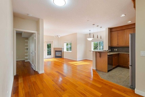 202-509 21 Avenue Sw, Calgary, AB - Indoor Photo Showing Kitchen With Fireplace