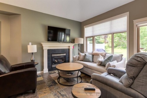 218 Springbank Villas Sw, Calgary, AB - Indoor Photo Showing Living Room With Fireplace