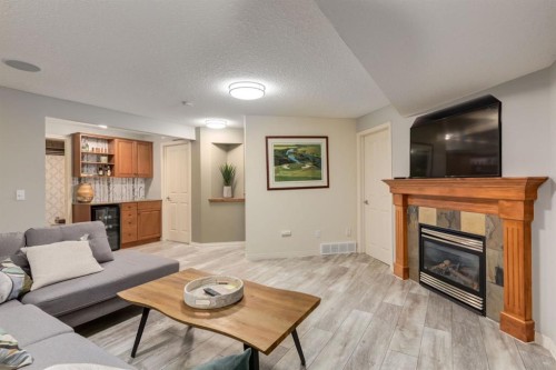 218 Springbank Villas Sw, Calgary, AB - Indoor Photo Showing Living Room With Fireplace