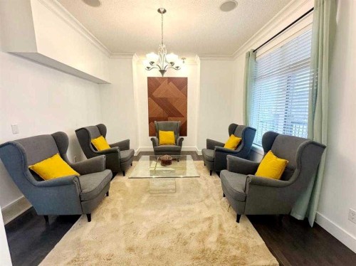 109 Kinniburgh Boulevard E Boulevard East, Chestermere, AB - Indoor Photo Showing Living Room With Fireplace