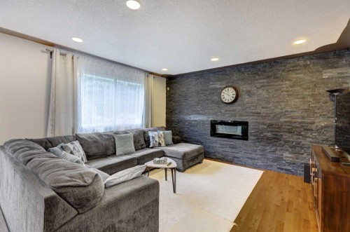 85 Sidon Crescent Sw, Calgary, AB - Indoor Photo Showing Living Room With Fireplace