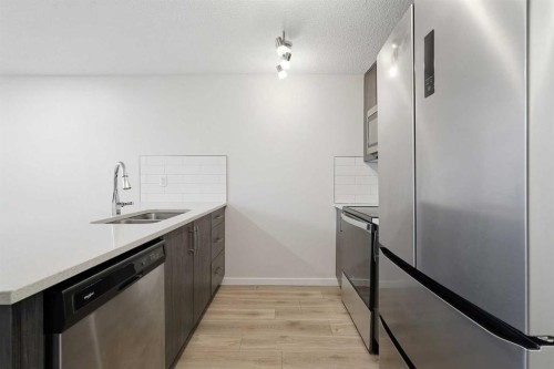 124 Cranbrook Square Se, Calgary, AB - Indoor Photo Showing Kitchen With Stainless Steel Kitchen With Double Sink