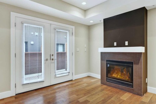 10-1717 27 Avenue Sw, Calgary, AB - Indoor Photo Showing Living Room With Fireplace