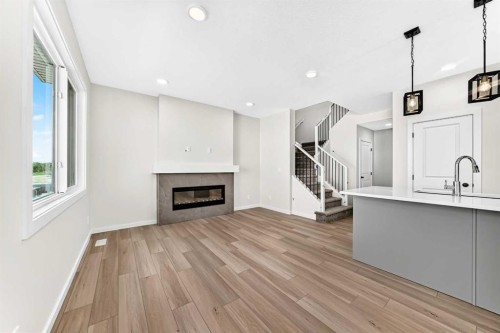 135 Mallard Heath Se, Calgary, AB - Indoor Photo Showing Other Room With Fireplace