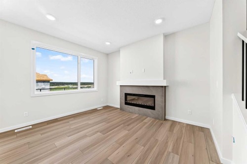 135 Mallard Heath Se, Calgary, AB - Indoor Photo Showing Living Room With Fireplace