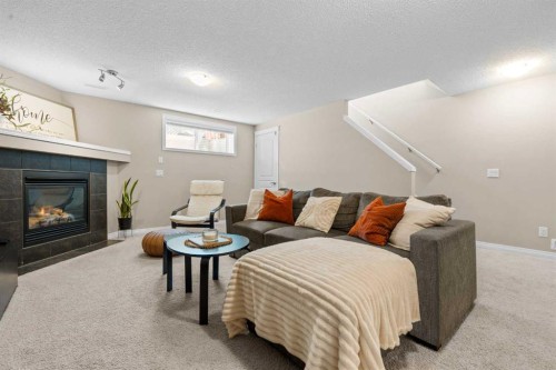 38 Auburn Bay Gardens Se, Calgary, AB - Indoor Photo Showing Living Room With Fireplace