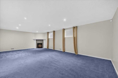 21 Strathearn Gardens Sw, Calgary, AB - Indoor With Fireplace