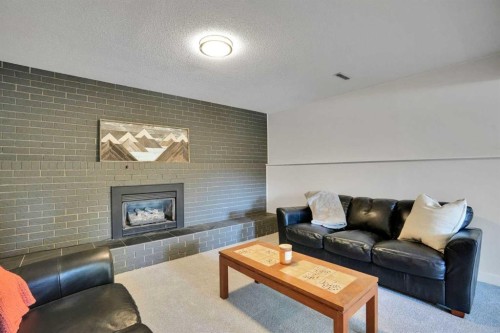 9667 Oakhill Drive Sw, Calgary, AB - Indoor Photo Showing Living Room With Fireplace