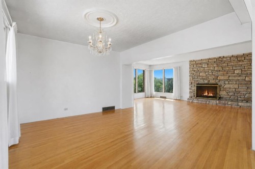 1556 Windsor Street Nw, Calgary, AB - Indoor Photo Showing Living Room With Fireplace