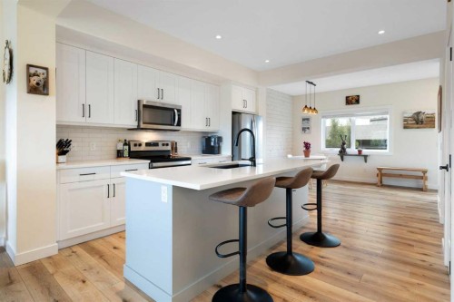 49 River Heights Drive, Cochrane, AB - Indoor Photo Showing Kitchen With Stainless Steel Kitchen With Upgraded Kitchen