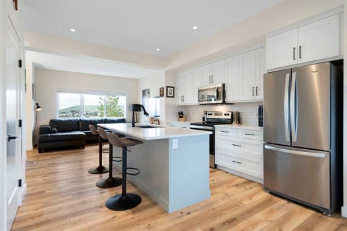49 River Heights Drive, Cochrane, AB - Indoor Photo Showing Kitchen With Stainless Steel Kitchen With Upgraded Kitchen