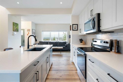 49 River Heights Drive, Cochrane, AB - Indoor Photo Showing Kitchen With Stainless Steel Kitchen With Upgraded Kitchen