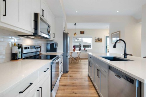 49 River Heights Drive, Cochrane, AB - Indoor Photo Showing Kitchen With Stainless Steel Kitchen With Upgraded Kitchen