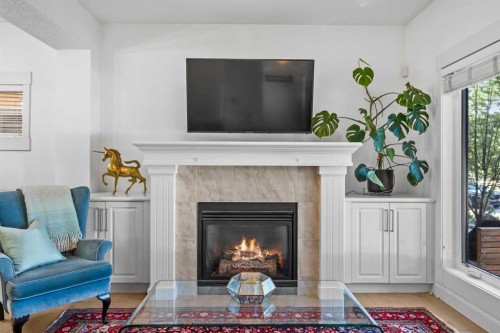 1-4711 17 Avenue Nw, Calgary, AB - Indoor Photo Showing Living Room With Fireplace