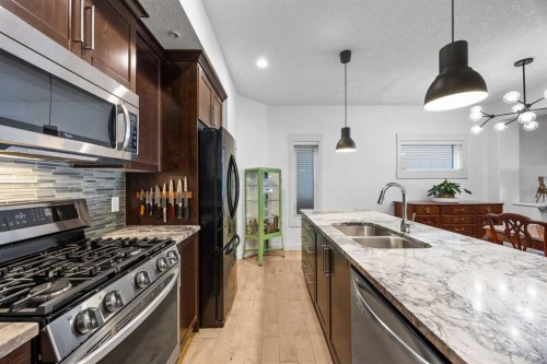 1-4711 17 Avenue Nw, Calgary, AB - Indoor Photo Showing Kitchen With Stainless Steel Kitchen With Double Sink With Upgraded Kitchen