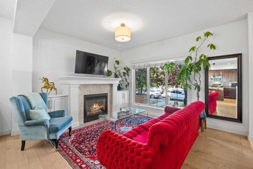 1-4711 17 Avenue Nw, Calgary, AB - Indoor Photo Showing Living Room With Fireplace