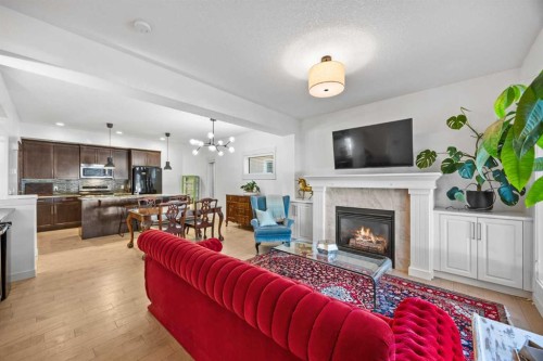 1-4711 17 Avenue Nw, Calgary, AB - Indoor Photo Showing Living Room With Fireplace