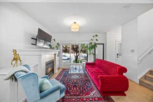 1-4711 17 Avenue Nw, Calgary, AB - Indoor Photo Showing Living Room With Fireplace