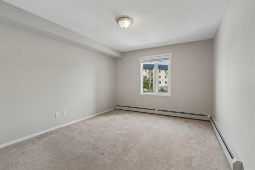 7207-304 Mackenzie Way Sw, Airdrie, AB - Indoor Photo Showing Other Room