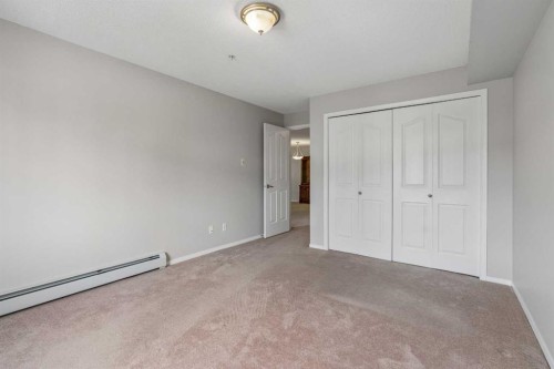 7207-304 Mackenzie Way Sw, Airdrie, AB - Indoor Photo Showing Other Room