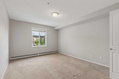 7207-304 Mackenzie Way Sw, Airdrie, AB - Indoor Photo Showing Other Room